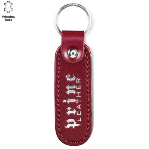 Crveni kožni privezak sa metalnim prstenom i belim natpisom "Princ Leather".