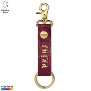 Crveni kožni privezak sa zlatnim metalnim kopčama i natpisom Princ Leather.