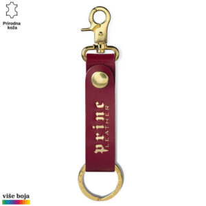 Privezak od prave kože sa metalnim kopčom i natpisom "Princ Leather" u zlatnoj boji.